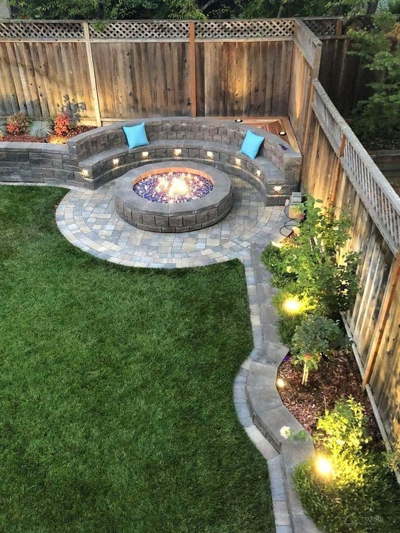 Curved stone fire pit with glass fire