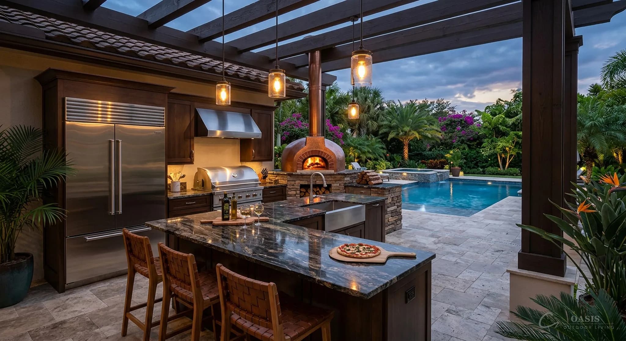 Luxury outdoor kitchen with pizza oven overlooking pool